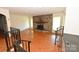 Cozy living room with a stone fireplace, large window, and hardwood floors for a timeless appeal at 157 Blackberry Ln, Taylorsville, NC 28681