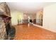 Charming living room with a stone fireplace, stairs, and wood floors that add warmth to the space at 157 Blackberry Ln, Taylorsville, NC 28681