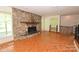 Spacious living room featuring a stone fireplace and hardwood floors for a cozy atmosphere at 157 Blackberry Ln, Taylorsville, NC 28681