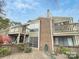 Charming exterior with brick and siding, plus private decks, all nestled amongst mature trees at 1600 Sharon W Rd # 16, Charlotte, NC 28210