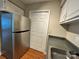 Galley kitchen featuring stainless steel refrigerator and convenient pantry storage at 1600 Sharon W Rd # 16, Charlotte, NC 28210