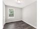 Empty bedroom with luxury vinyl plank flooring, a window, and fresh neutral paint at 1675 Old Lynwood Cir, Lancaster, SC 29720