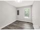 A simply decorated bedroom with a gray paint and luxury vinyl plank flooring at 1675 Old Lynwood Cir, Lancaster, SC 29720