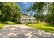 Inviting one-story home framed by mature trees, featuring a cozy porch and a spacious front yard at 1675 Old Lynwood Cir, Lancaster, SC 29720