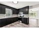 Galley kitchen featuring black cabinets, light countertops, and a stainless steel oven at 1675 Old Lynwood Cir, Lancaster, SC 29720