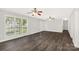 Bright living room with large windows, modern flooring, ceiling fans, and neutral paint at 1675 Old Lynwood Cir, Lancaster, SC 29720