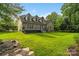 Expansive backyard featuring a well-maintained lawn, deck, and mature trees, enhancing privacy at 1812 Mill Chase Ln, Waxhaw, NC 28173