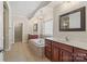 Bright bathroom featuring double vanities, a soaking tub, a separate shower, and tile flooring at 1812 Mill Chase Ln, Waxhaw, NC 28173