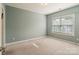 Bedroom with light blue walls, neutral carpet, and a window at 1812 Mill Chase Ln, Waxhaw, NC 28173
