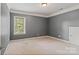 Gray bedroom with a window for natural light and neutral carpet at 1812 Mill Chase Ln, Waxhaw, NC 28173