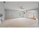 Large bonus room with neutral carpet, ceiling fan, and multiple windows for natural light at 1812 Mill Chase Ln, Waxhaw, NC 28173