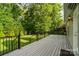 Large deck with black railing, surrounded by lush greenery offering privacy and outdoor enjoyment at 1812 Mill Chase Ln, Waxhaw, NC 28173