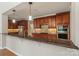 Beautiful kitchen island featuring granite countertops, wooden cabinetry, and stainless steel appliances at 1812 Mill Chase Ln, Waxhaw, NC 28173