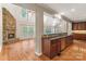 Open-concept kitchen with a stone fireplace, hardwood floors, and ample counter space at 1812 Mill Chase Ln, Waxhaw, NC 28173