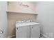 Bright laundry room with a new washer and dryer and ample storage space at 1812 Mill Chase Ln, Waxhaw, NC 28173