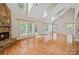 Large living room with stone fireplace, hardwood floors, tall ceilings, and natural light at 1812 Mill Chase Ln, Waxhaw, NC 28173