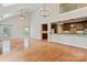 Spacious living area with hardwood floors, vaulted ceilings, open layout, and kitchen access at 1812 Mill Chase Ln, Waxhaw, NC 28173