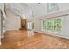 Bright living room with vaulted ceilings, stone fireplace, hardwood floors, and backyard access at 1812 Mill Chase Ln, Waxhaw, NC 28173