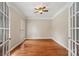 Office space with hardwood floors, neutral paint, transom window and french doors for professional appeal at 1812 Mill Chase Ln, Waxhaw, NC 28173
