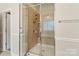 Walk-in shower featuring a glass enclosure, tile surround, and chrome fixtures at 1812 Mill Chase Ln, Waxhaw, NC 28173