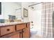 Bathroom with granite countertop vanity, framed mirror and shower with striped curtain at 18236 Coulter Pkwy, Cornelius, NC 28031