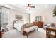 Comfortable bedroom with a decorative ceiling fan, wood furniture, and neutral decor at 18236 Coulter Pkwy, Cornelius, NC 28031