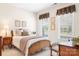 Inviting bedroom with soft lighting, framed art, and a cozy window nook at 18236 Coulter Pkwy, Cornelius, NC 28031