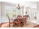 Bright dining room with wainscoting, chandelier, plantation shutters, and hardwood floors at 18236 Coulter Pkwy, Cornelius, NC 28031