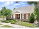A beautiful stone-accented home with a manicured lawn, shrubs, and well-placed tree in a desirable neighborhood at 18236 Coulter Pkwy, Cornelius, NC 28031