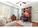 Comfortable home office with a built-in desk, a ceiling fan, and a sofa at 18236 Coulter Pkwy, Cornelius, NC 28031