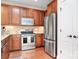 Well-lit kitchen featuring stainless steel appliances, granite countertops, and wooden cabinetry at 18236 Coulter Pkwy, Cornelius, NC 28031