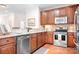 Well-equipped kitchen features stainless steel appliances, granite countertops, and warm wood cabinets at 18236 Coulter Pkwy, Cornelius, NC 28031
