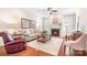 Inviting living room with a cozy fireplace, neutral furniture, hardwood floors, and natural light at 18236 Coulter Pkwy, Cornelius, NC 28031