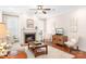 A welcoming living room with a fireplace, warm lighting, and hardwood floors at 18236 Coulter Pkwy, Cornelius, NC 28031