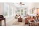 Cozy sunroom with lots of natural light, stylish wicker furniture, and tile flooring at 18236 Coulter Pkwy, Cornelius, NC 28031