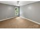Bright bedroom features plush carpet, neutral walls, and a ceiling fan at 2027 Brook View Ct, Matthews, NC 28104