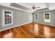 Spacious bedroom featuring hardwood floors, a tray ceiling, and plenty of natural light at 2027 Brook View Ct, Matthews, NC 28104