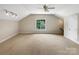 Expansive bonus room with carpet, ceiling fan, a bright window, and neutral paint at 2027 Brook View Ct, Matthews, NC 28104
