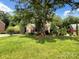 Traditional brick home with mature trees offering shade and curb appeal at 2027 Brook View Ct, Matthews, NC 28104