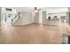 Open-concept living area with tile flooring, staircase, and views of the kitchen at 2027 Brook View Ct, Matthews, NC 28104