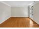 Bright living room with hardwood floors, crown molding, and large shuttered windows at 2027 Brook View Ct, Matthews, NC 28104
