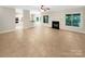Bright and airy living room with a fireplace and large windows offering plenty of natural light at 2027 Brook View Ct, Matthews, NC 28104