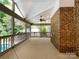 Spacious screened-in porch with brick accent wall, ceiling fan, and views of the backyard at 2027 Brook View Ct, Matthews, NC 28104
