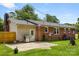Backyard featuring a red brick house, small patio with grill, and a grassy area with mature trees at 2476 Cane Mill Rd, Lancaster, SC 29720