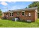 View of a red brick home with green lawn, AC unit, utility hookups, and side door at 2476 Cane Mill Rd, Lancaster, SC 29720