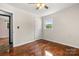 Bright bedroom with a ceiling fan, hardwood floors, neutral walls, and a view to the exterior through a window at 2476 Cane Mill Rd, Lancaster, SC 29720