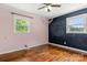 Bedroom with hardwood floors, pink and chalkboard accent walls, and natural light from windows at 2476 Cane Mill Rd, Lancaster, SC 29720