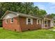 Brick house featuring classic shutters, a well-manicured lawn, and a cozy front porch at 2476 Cane Mill Rd, Lancaster, SC 29720