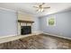 Cozy living room featuring a vintage fireplace, ceiling fan, and durable wood-look floors at 2476 Cane Mill Rd, Lancaster, SC 29720