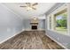 Spacious living room showcasing durable flooring, a fireplace, and bright natural light from large windows at 2476 Cane Mill Rd, Lancaster, SC 29720